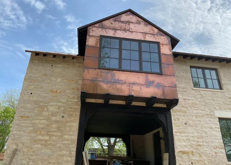 Copper metal panel facade on a stone building for Skylight Installation in West Modesto